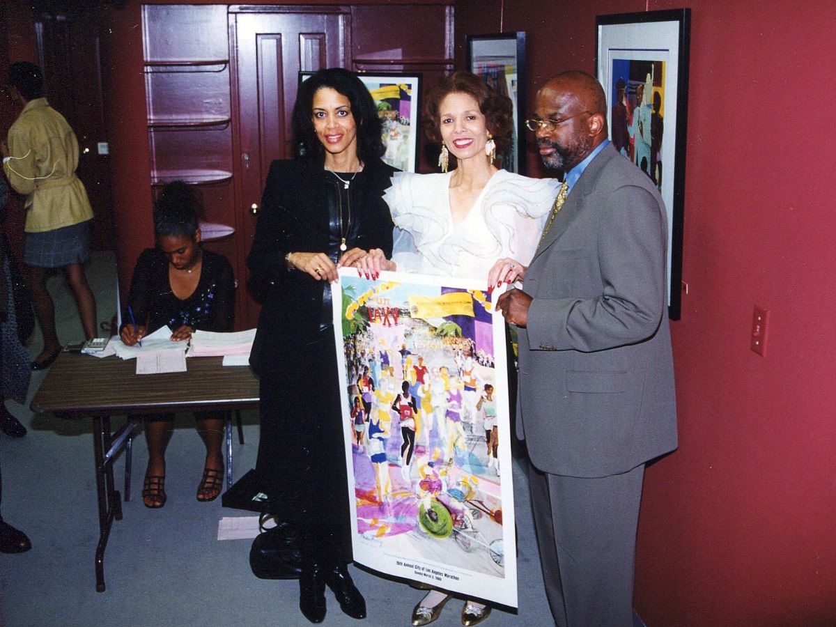 Three people holding a poster in front of a wall.