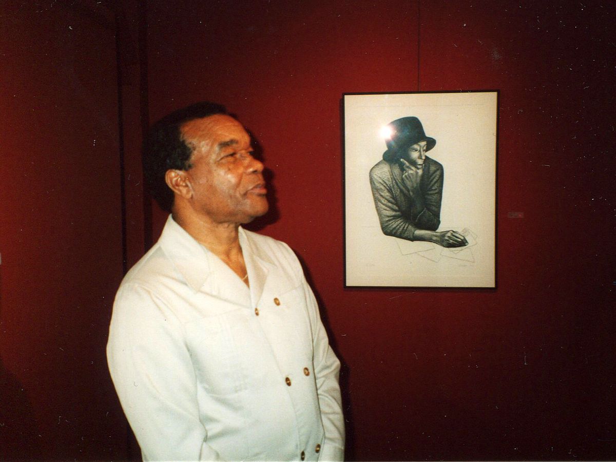 A man standing in front of a picture.