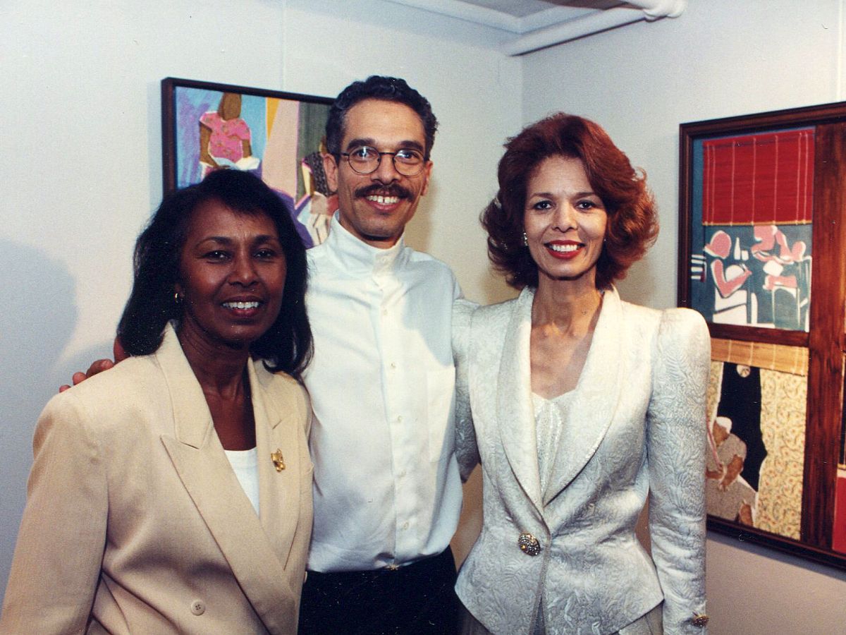 Three people in suits posing for a picture.
