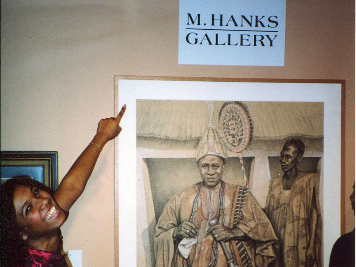 A person pointing to an image of a man in a robe.