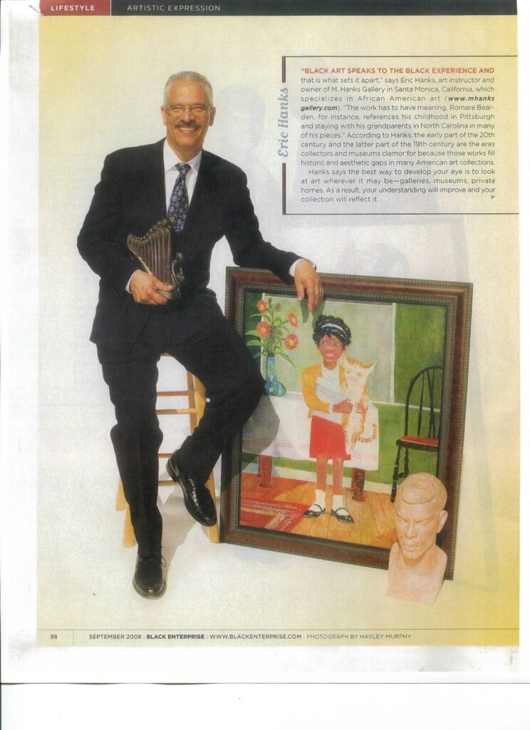 A man sitting in front of a painting.