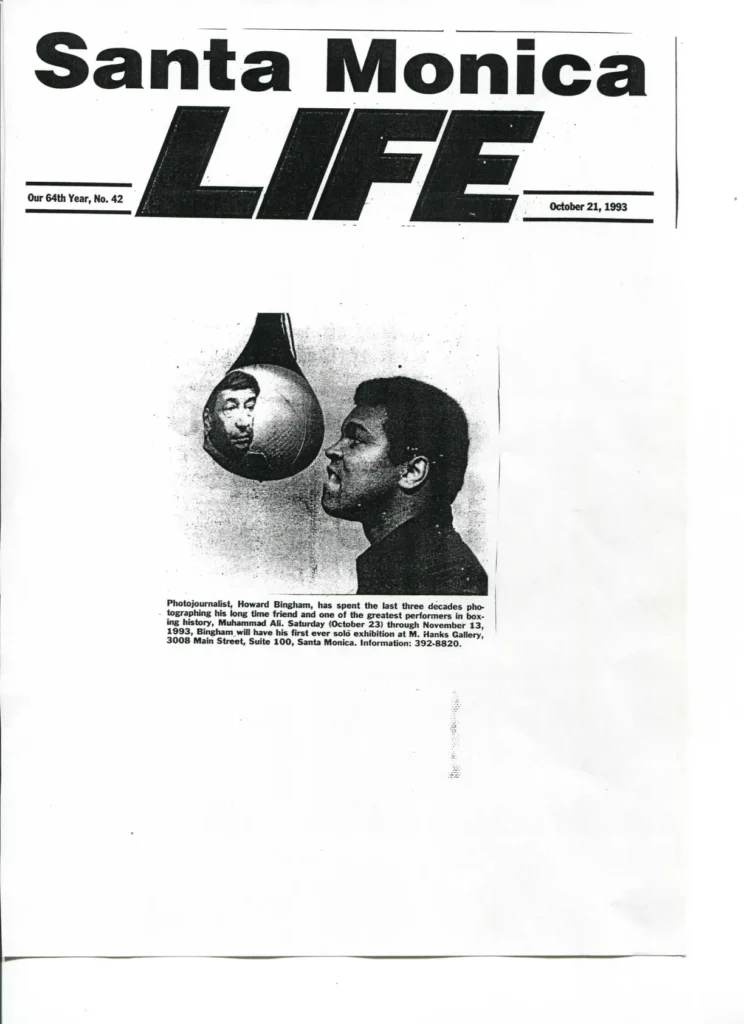 A black and white photo of a man with a boxing glove.