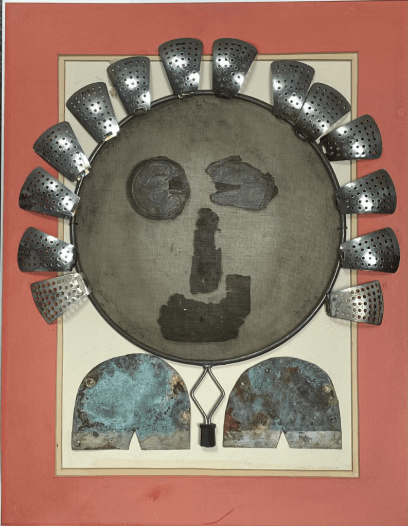 A metal face with many metal shields around it.